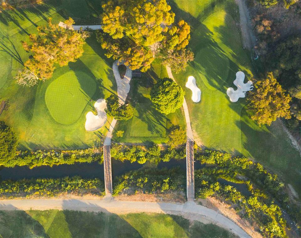 Drone image of golf course with two bridges