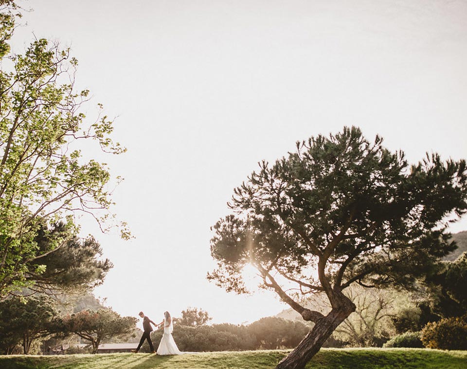 Bride and Groom Walking in the Sunset