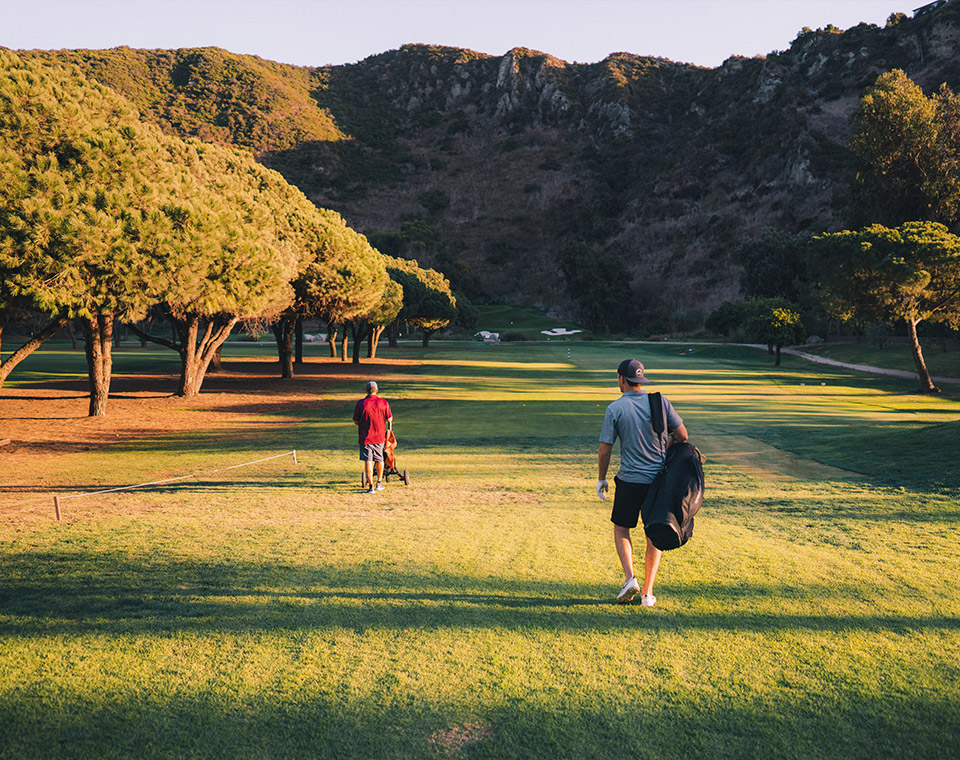 Golfers walking on the first fairway