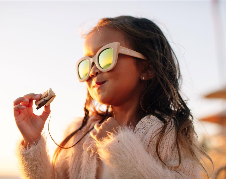 Little girl eating s'mores at Lost Pier Cafe