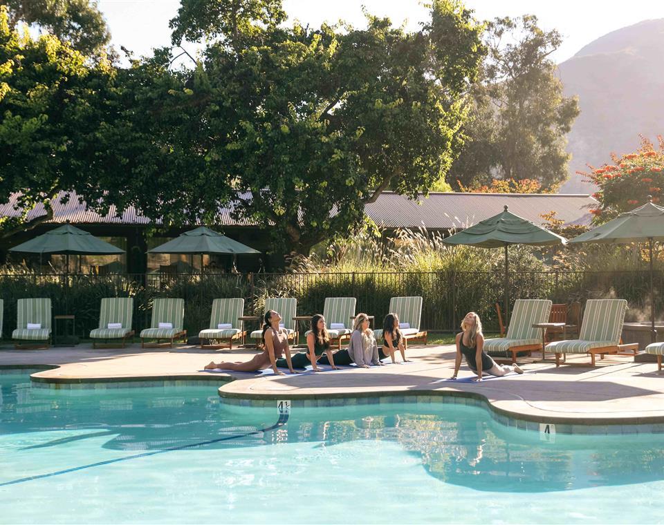 Guests doing Yoga at the pool 